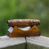 A traditional Maori style ornamental carved wooden "Koauau" or three hole flute