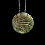 Hand carved Jade disc pendant with korus by Nick and Mady