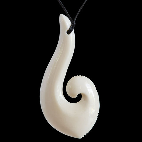 HAND CARVED NATURAL BONE HOOK WITH MANAIA FACE PENDANT. BONE HOOK